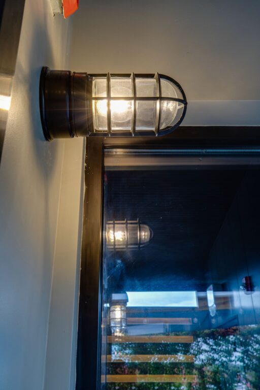 IMG 5541 fused flush mount guard sconce industrial atomic standard cast guard clear glass on 100 black commercial interior