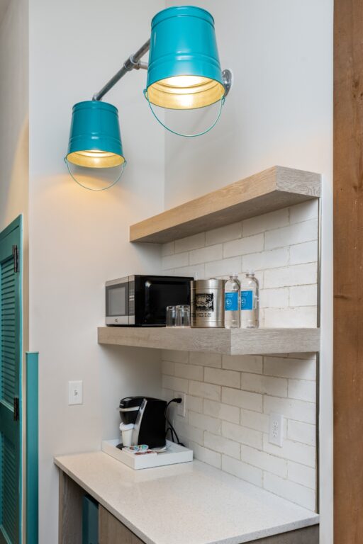 https://cdn.barnlight.com/inspiration/wp-content/uploads/2023/07/Margaritaville-Lodge-23-Custom-Commercial-interior-lighting-on-hotel-coffee-bar-Bucket-Wall-Sconce-390-Teal-975-Galvanized-512x768.jpg